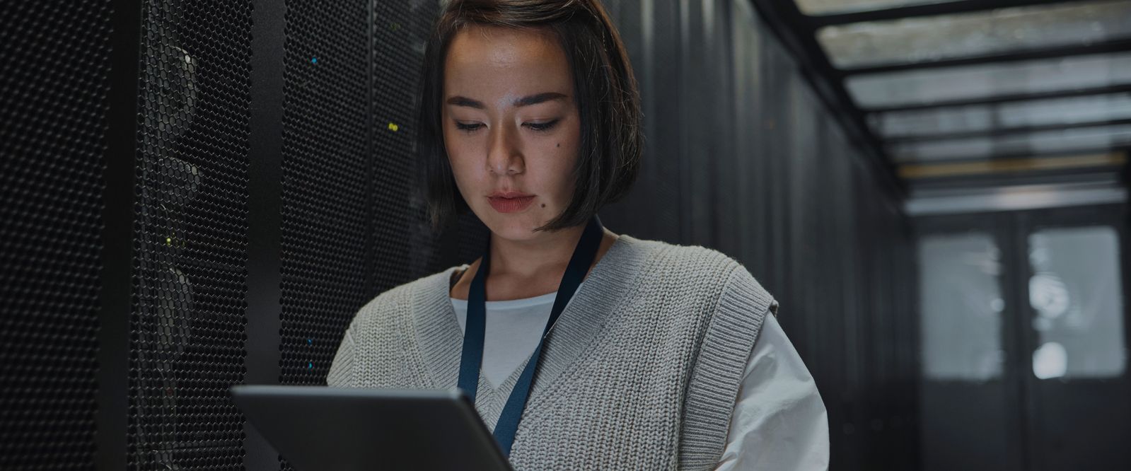 a person in a data centre looking at an ipad